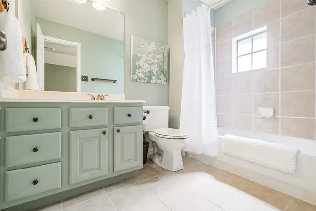 a spacious bathroom with a toilet a sink and bathtub