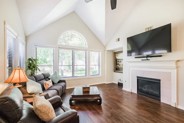 a living room with furniture a flat screen tv and a fireplace
