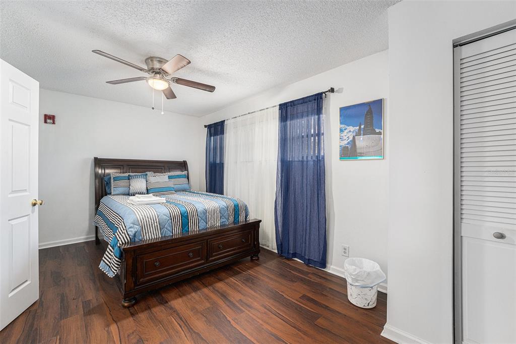 4609 Horton Road Plant City, FL 33567 - Photo 23 of 47 a bedroom with a bed and wooden floor