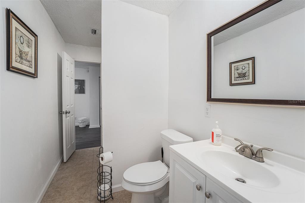 4609 Horton Road Plant City, FL 33567 - Photo 25 of 47 a bathroom with a toilet sink and mirror