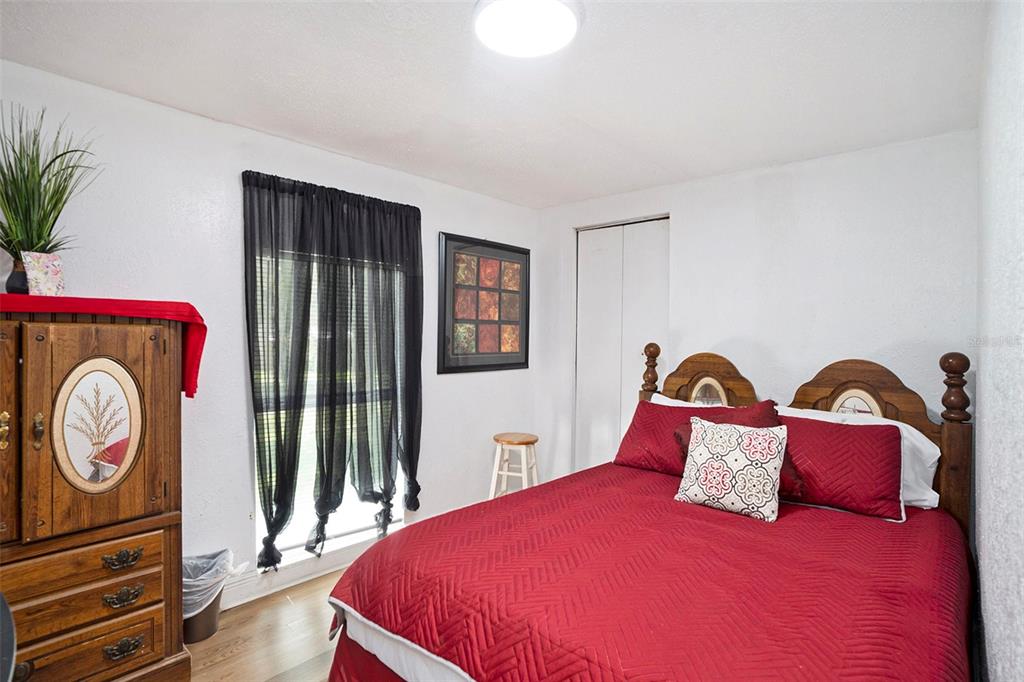 4609 Horton Road Plant City, FL 33567 - Photo 40 of 47 a bedroom with a bed and a chandelier