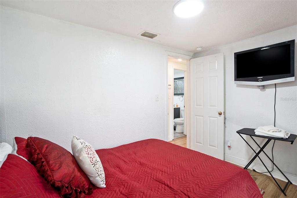 4609 Horton Road Plant City, FL 33567 - Photo 41 of 47 a bedroom with a bed and a flat screen tv