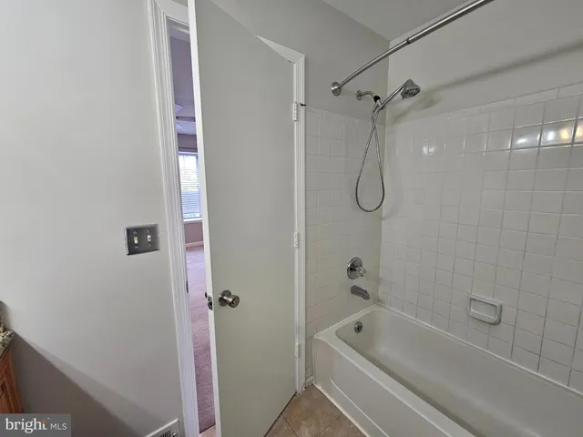 a bathroom with a bath tub with a shower