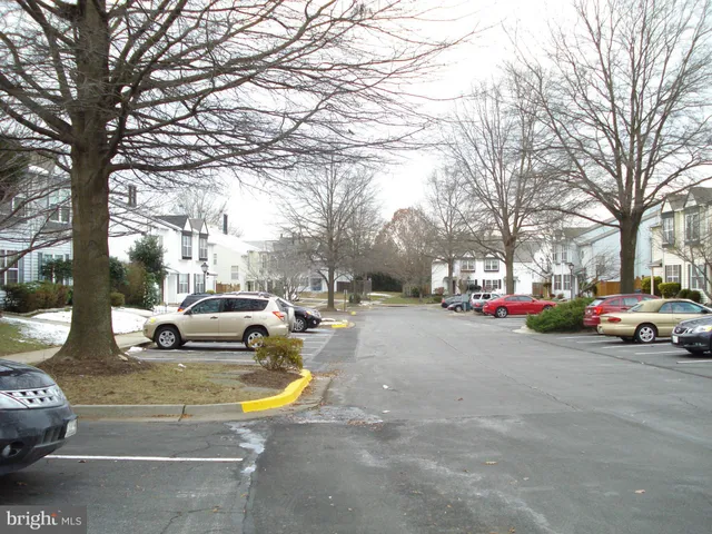 a view of staircase with lots of frames on wall and wooden floor