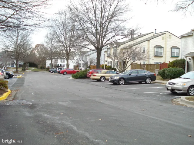 a view of a kitchen with wooden floor and electronic appliances