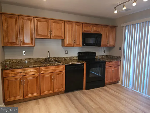 an empty room with a ceiling fan and a window