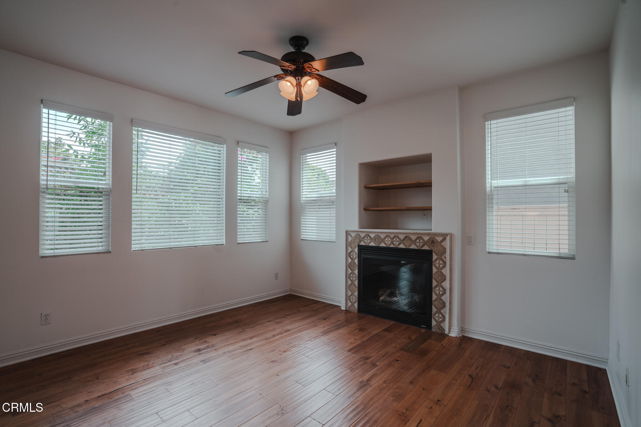 525 Shell Harbor Lane Port Hueneme, CA 93041 - Photo 16 of 47 a view of an empty room with wooden floor fireplace and a window