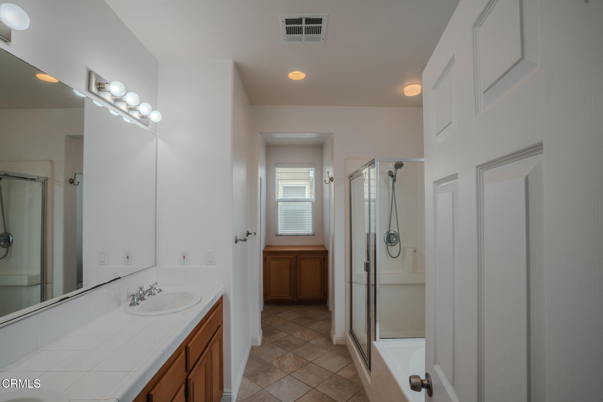 525 Shell Harbor Lane Port Hueneme, CA 93041 - Photo 28 of 47 a bathroom with a tub sink a shower and a mirror