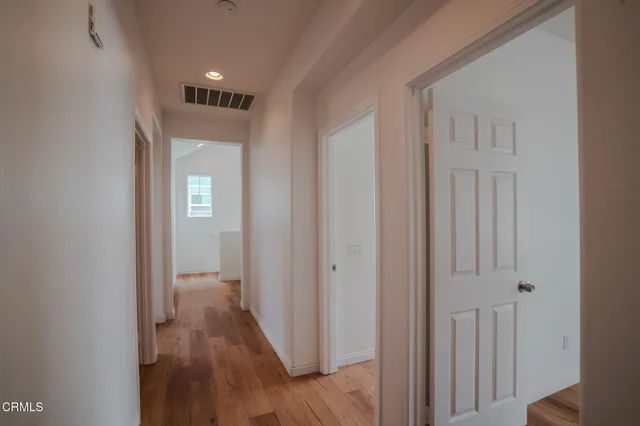 a view of a hallway with wooden floor