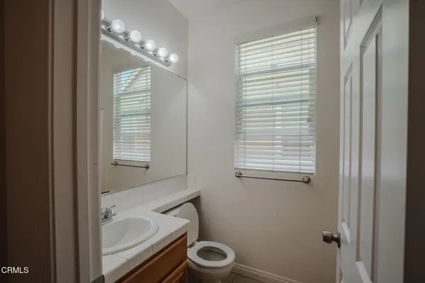 a bathroom with a granite countertop toilet a sink and a bathtub