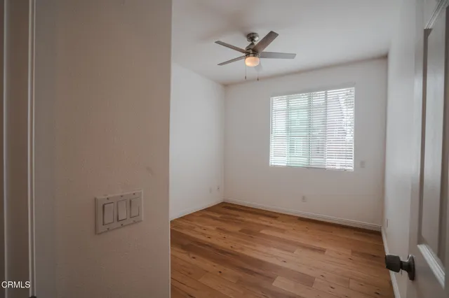 a view of a room with wooden floor and windows