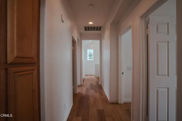 a view of hallway with wooden floor