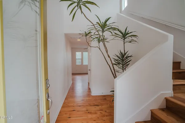 a view of a hallway with paintings on the wall