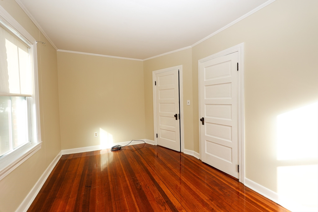354 Pond Street, Unit 354 Braintree, MA 02184 - Photo 11 of 30 a view of a room with wooden floor and window