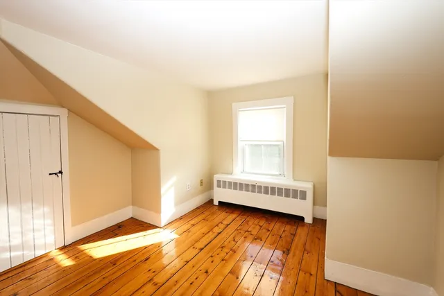 a view of an empty room and wooden floor