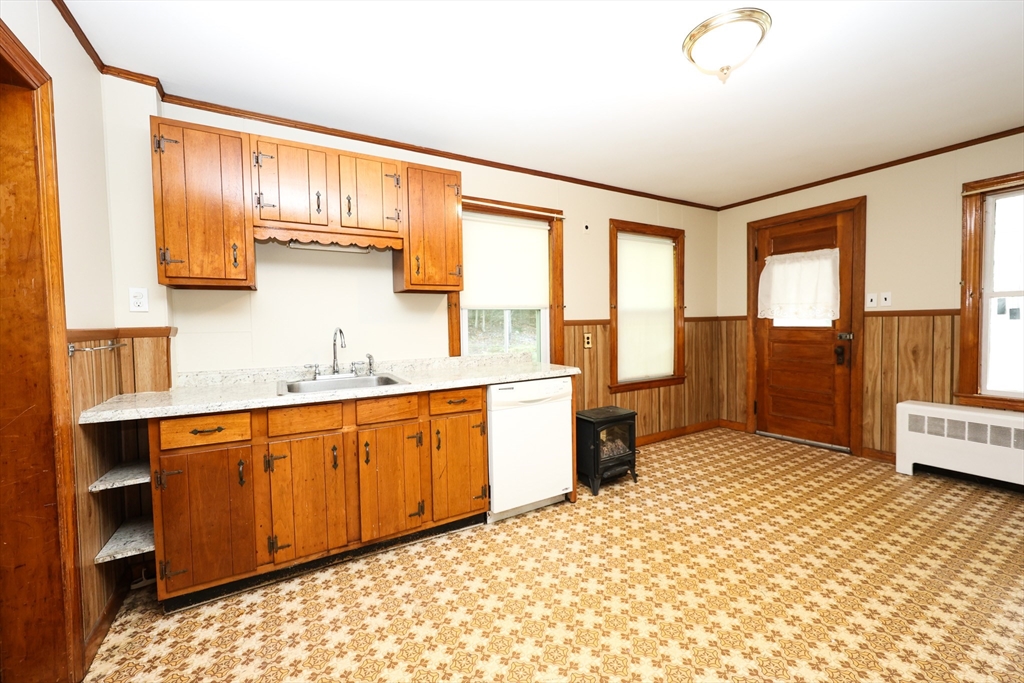 354 Pond Street, Unit 354 Braintree, MA 02184 - Photo 21 of 30 a spacious bathroom with a granite countertop sink and a large mirror