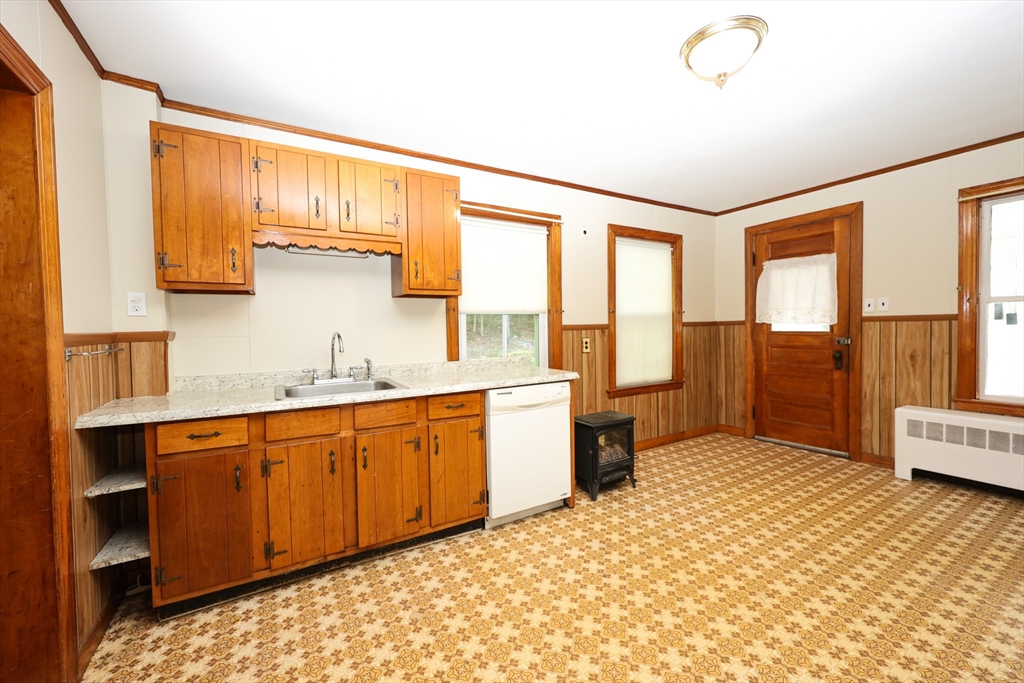 354 Pond Street, Unit 354 Braintree, MA 02184 - Photo 22 of 30 a spacious bathroom with a granite countertop sink and a large mirror