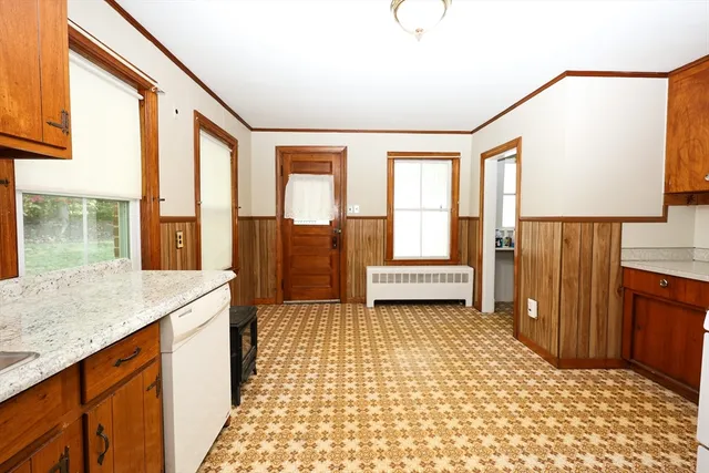 a bathroom with a granite countertop sink a mirror and a shower