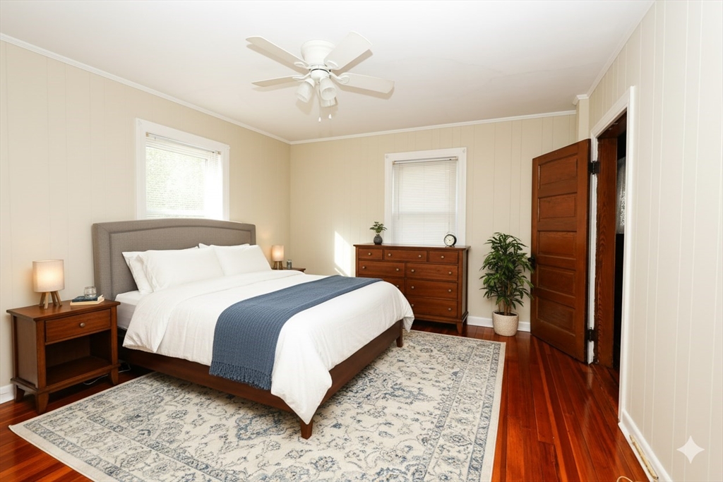 354 Pond Street, Unit 354 Braintree, MA 02184 - Photo 3 of 30 a bedroom with a bed and a view of bathroom