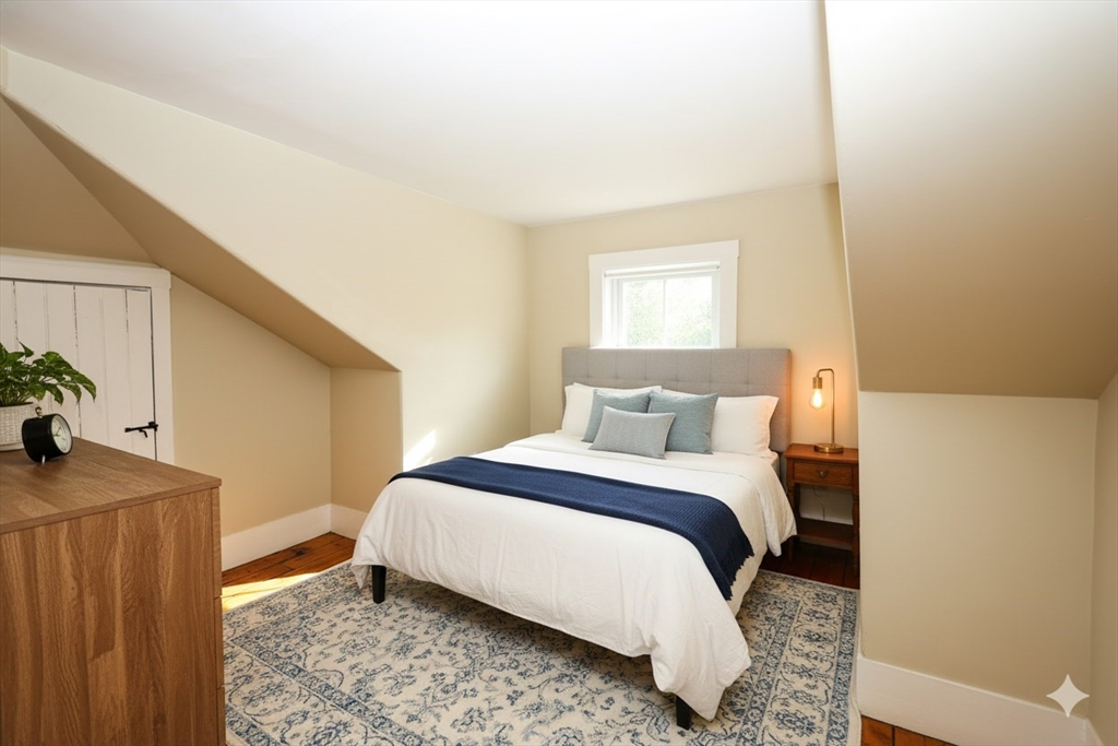 354 Pond Street, Unit 354 Braintree, MA 02184 - Photo 5 of 30 a bedroom with a bed and a dresser