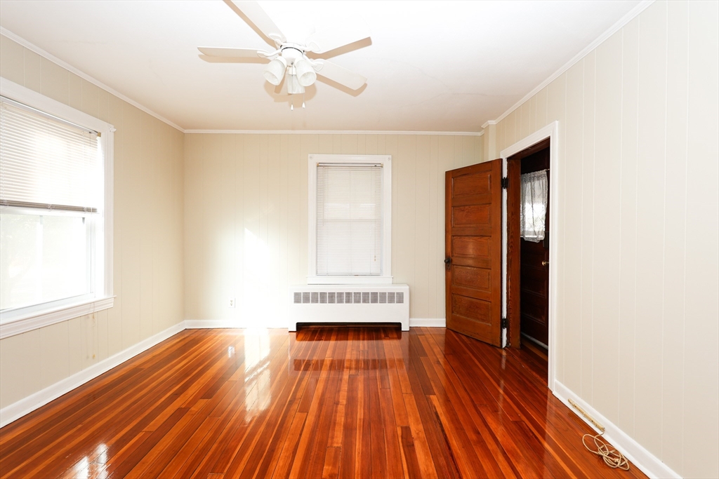 354 Pond Street, Unit 354 Braintree, MA 02184 - Photo 9 of 30 a view of a room with wooden floor and white walls