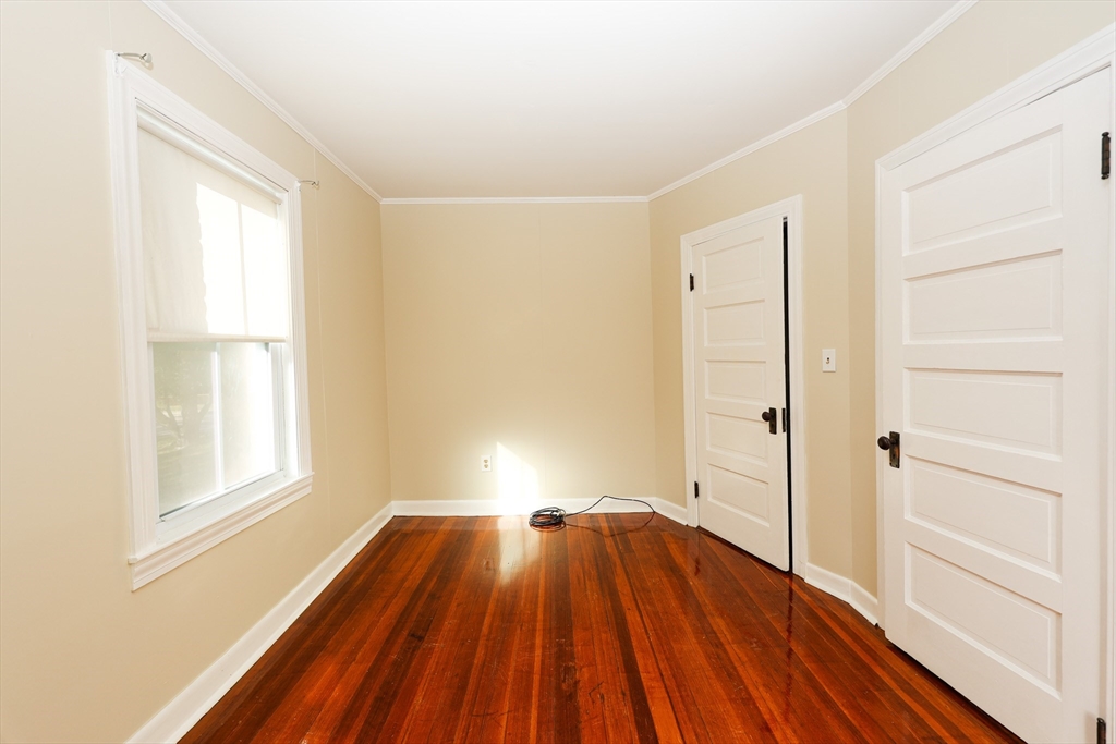 354 Pond Street, Unit 354 Braintree, MA 02184 - Photo 10 of 30 a view of a room with wooden floor closet and windows