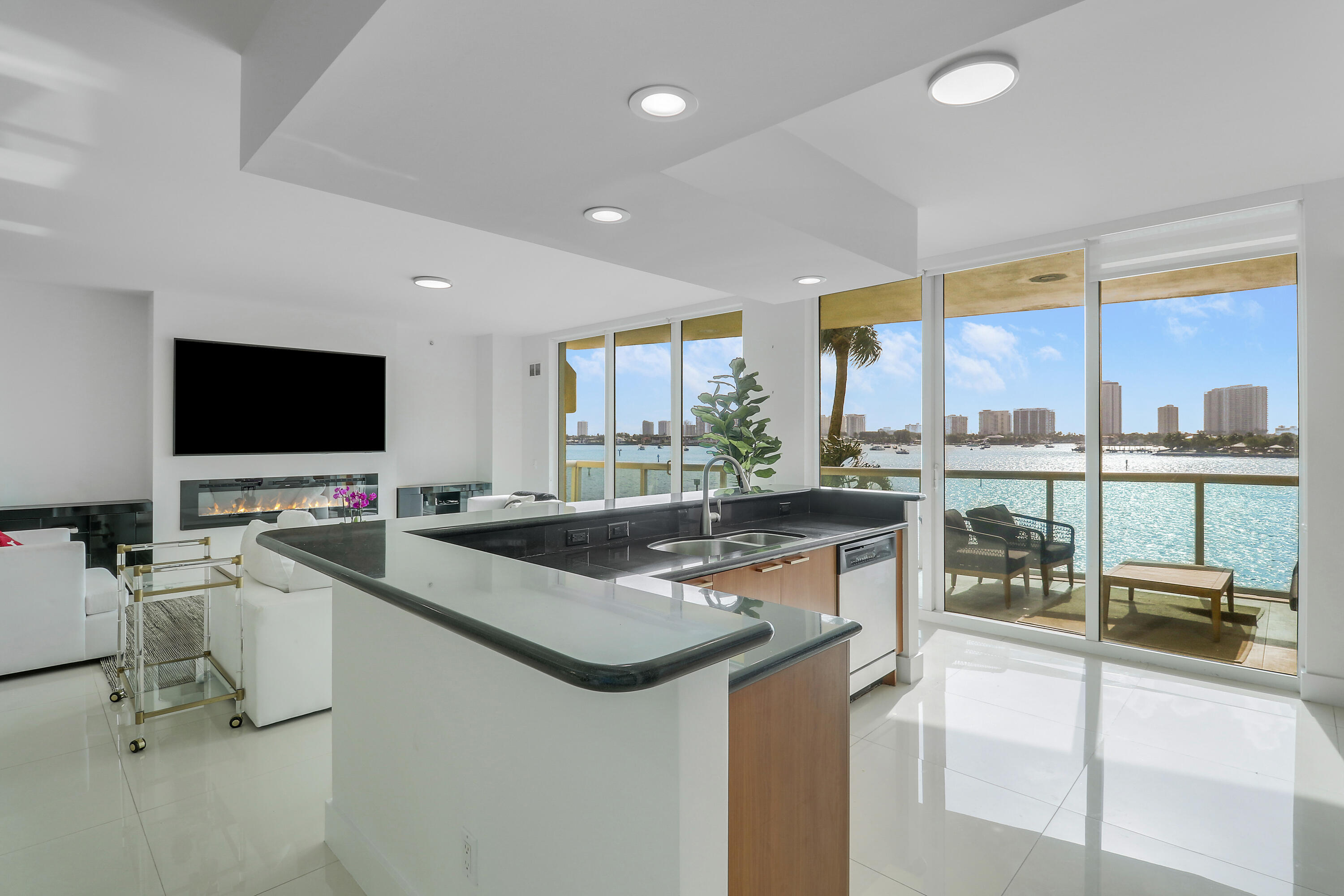 2640 Lake Shore Drive, Unit 307 Riviera Beach, FL 33404 - Photo 8 of 44 a room with furniture and a large window