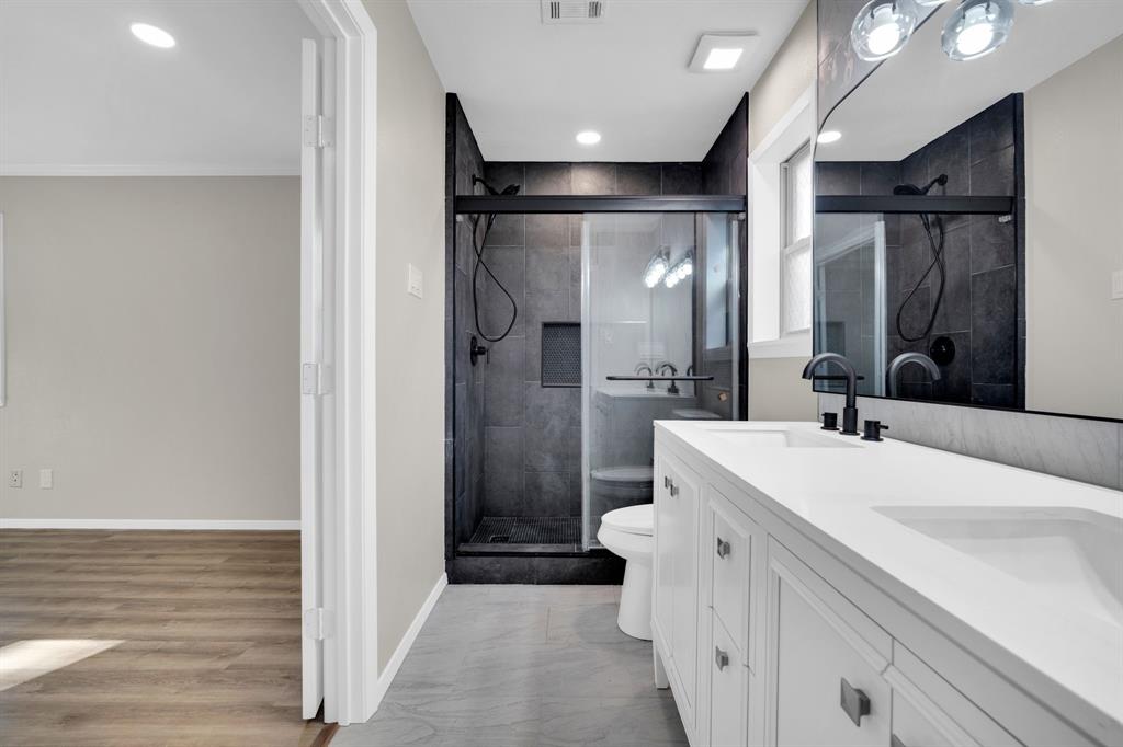 221 North Edgefield Road Waxahachie, TX 75165 - Photo 14 of 27 a bathroom with a sink a toilet and shower