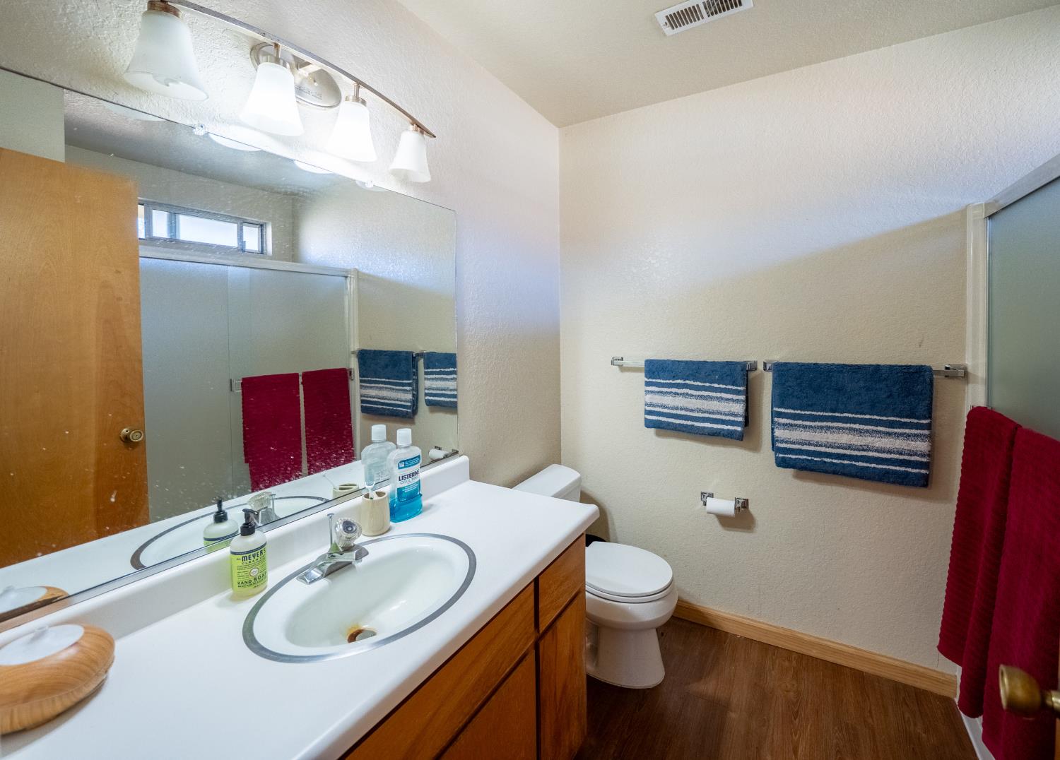 494 Surrey Court Murphys, CA 95247 - Photo 59 of 76 a bathroom with a toilet sink and mirror