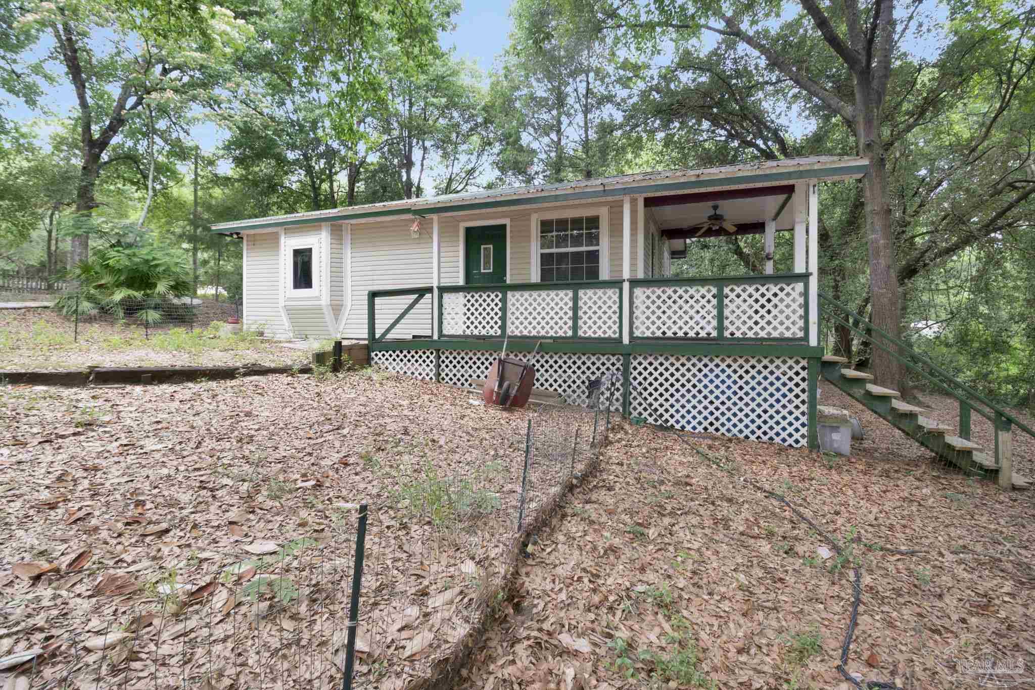 10290 West Lake Road Milton, FL 32583 - Photo 25 of 53 a front view of a house with a yard