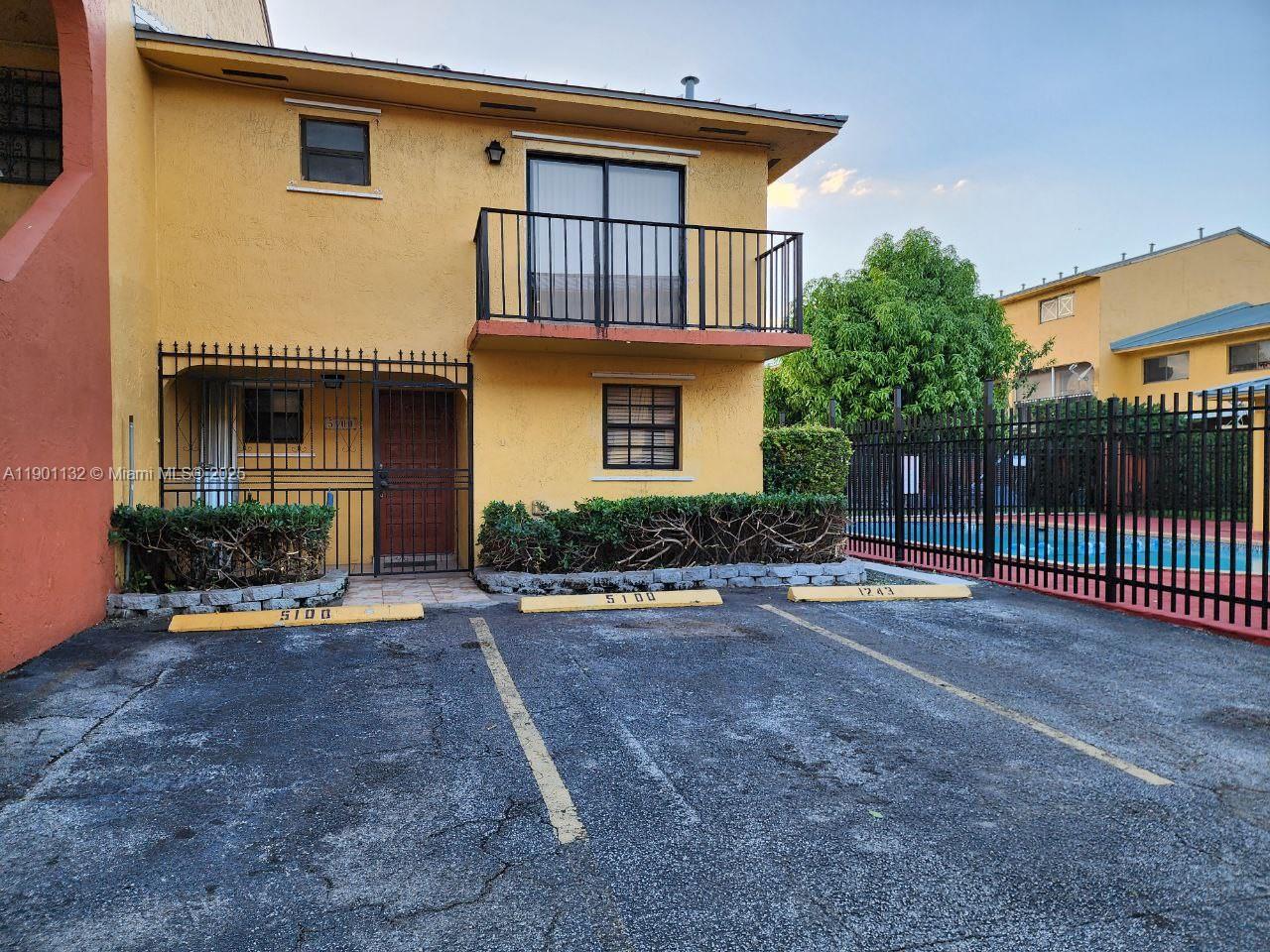 a view of a house with backyard and porch