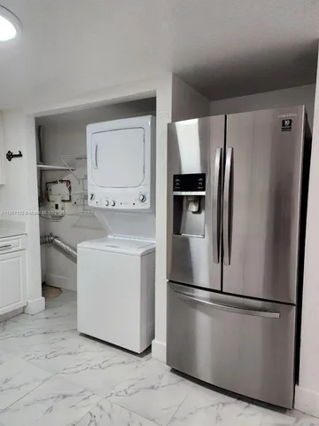 a kitchen with a refrigerator sink stove and microwave