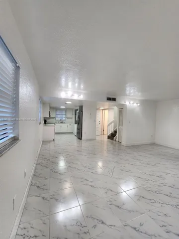 a view of a kitchen with a sink and cabinets