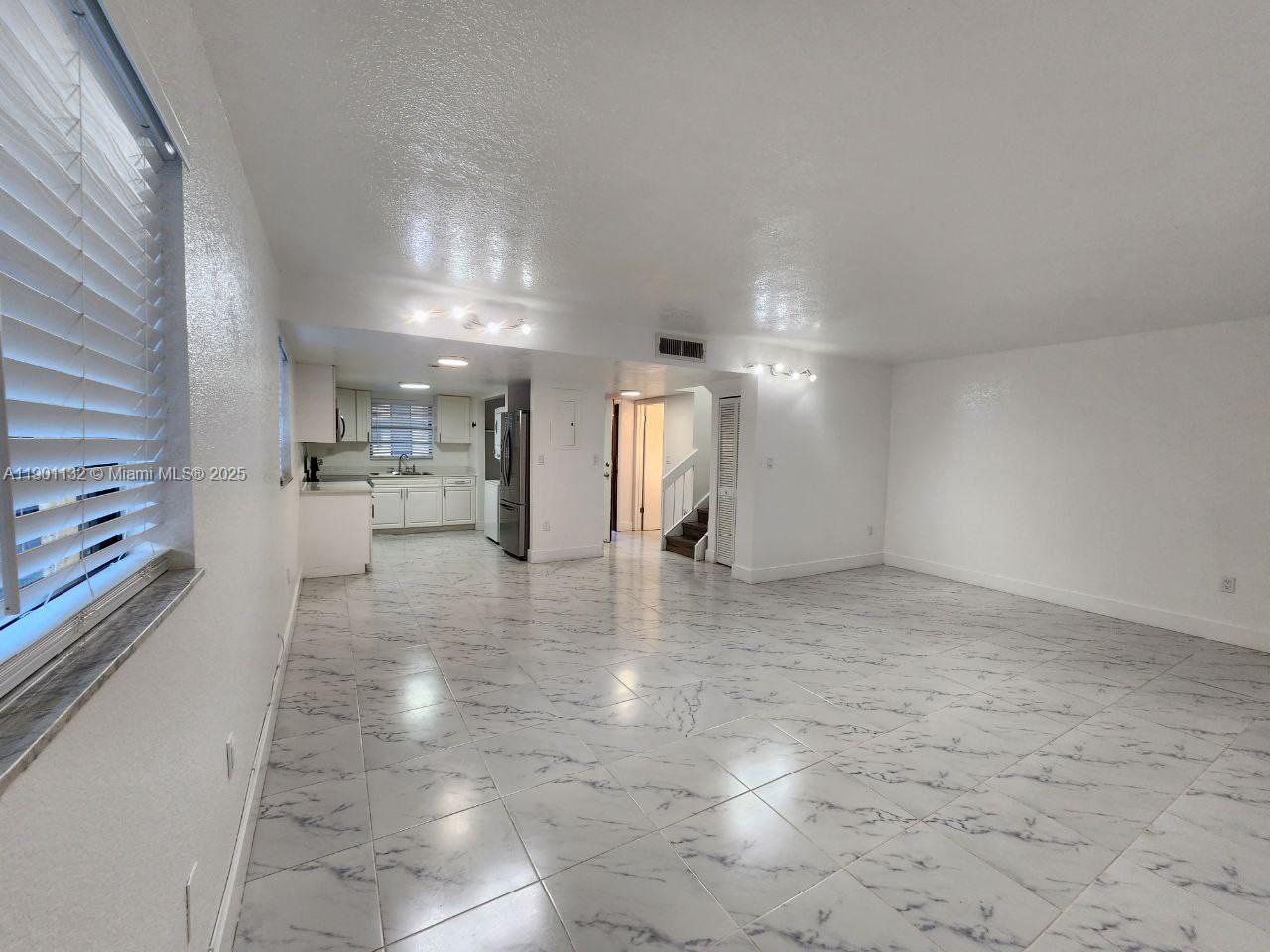 5100 West 12th Lane, Unit E7 Hialeah, FL 33012 - Photo 16 of 35 a view of a kitchen with a sink and cabinets
