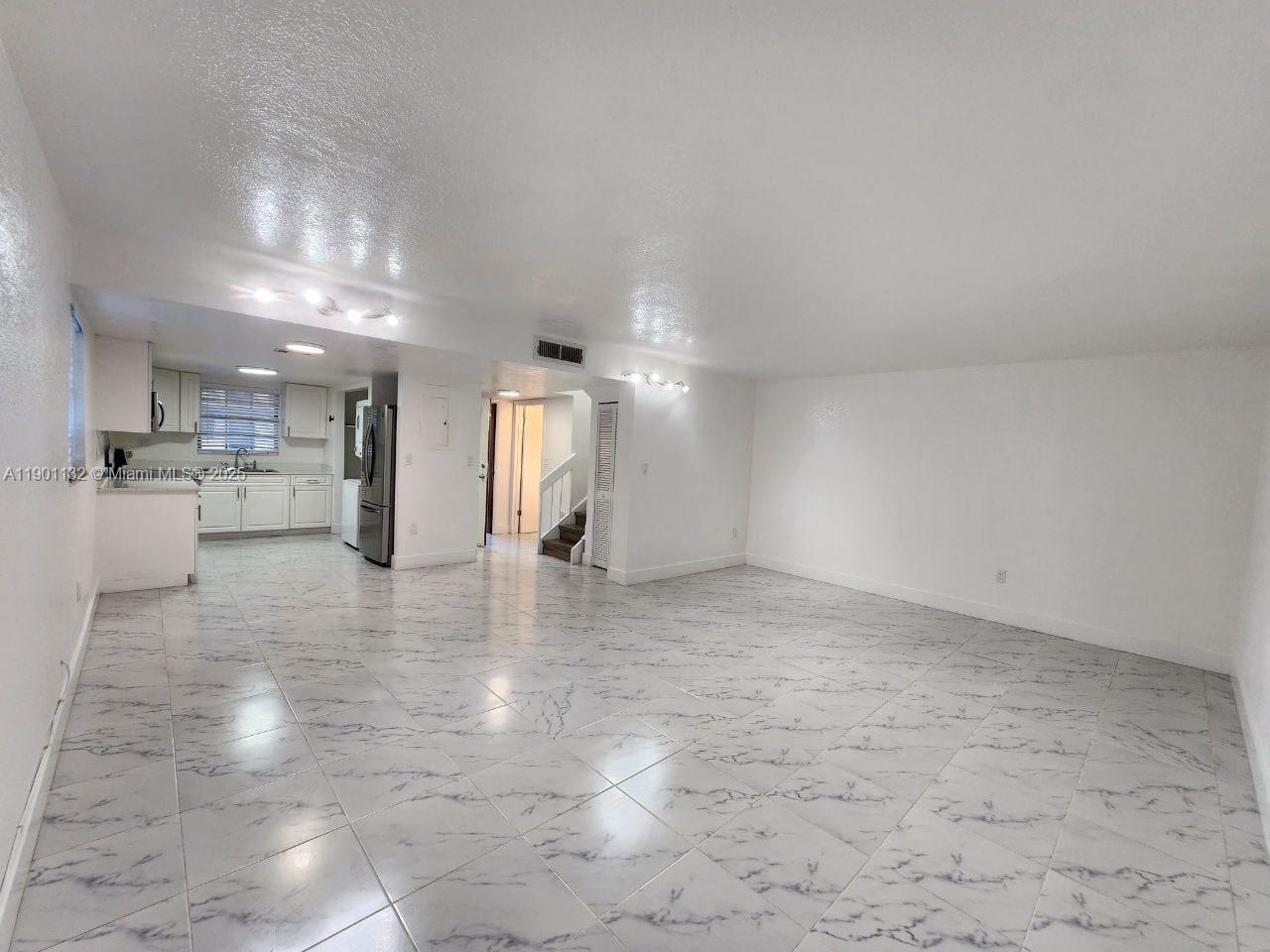 5100 West 12th Lane, Unit E7 Hialeah, FL 33012 - Photo 17 of 35 a view of a kitchen with a sink and a refrigerator