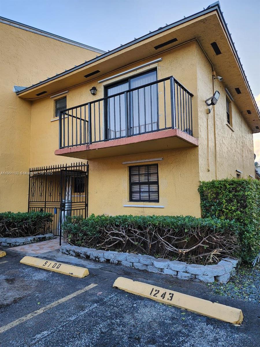 5100 West 12th Lane, Unit E7 Hialeah, FL 33012 - Photo 2 of 35 a front view of a house with garden