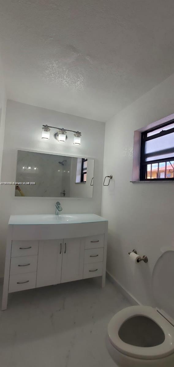5100 West 12th Lane, Unit E7 Hialeah, FL 33012 - Photo 30 of 35 a bathroom with a sink and a mirror