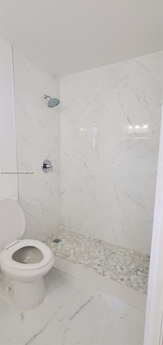5100 West 12th Lane, Unit E7 Hialeah, FL 33012 - Photo 31 of 35 a white toilet sitting next to a shower
