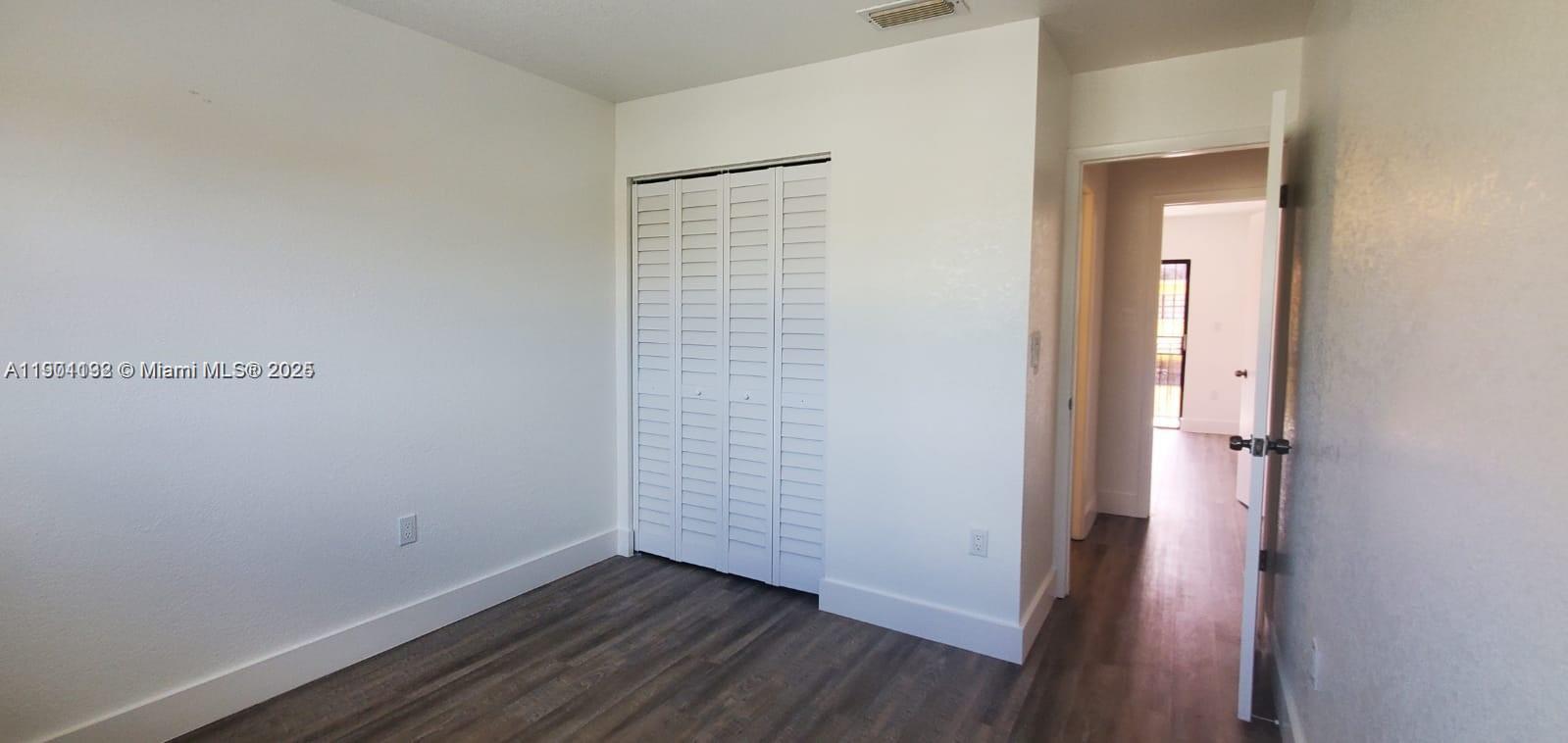5100 West 12th Lane, Unit E7 Hialeah, FL 33012 - Photo 33 of 35 a view of an empty room with closet and mirror