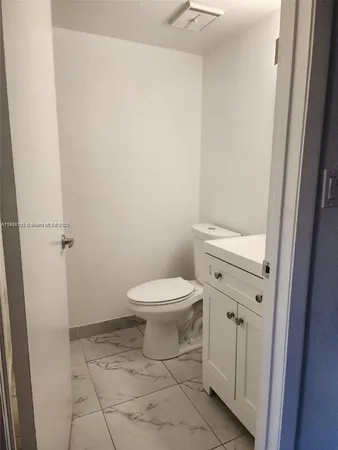 a kitchen with a refrigerator sink stove and microwave