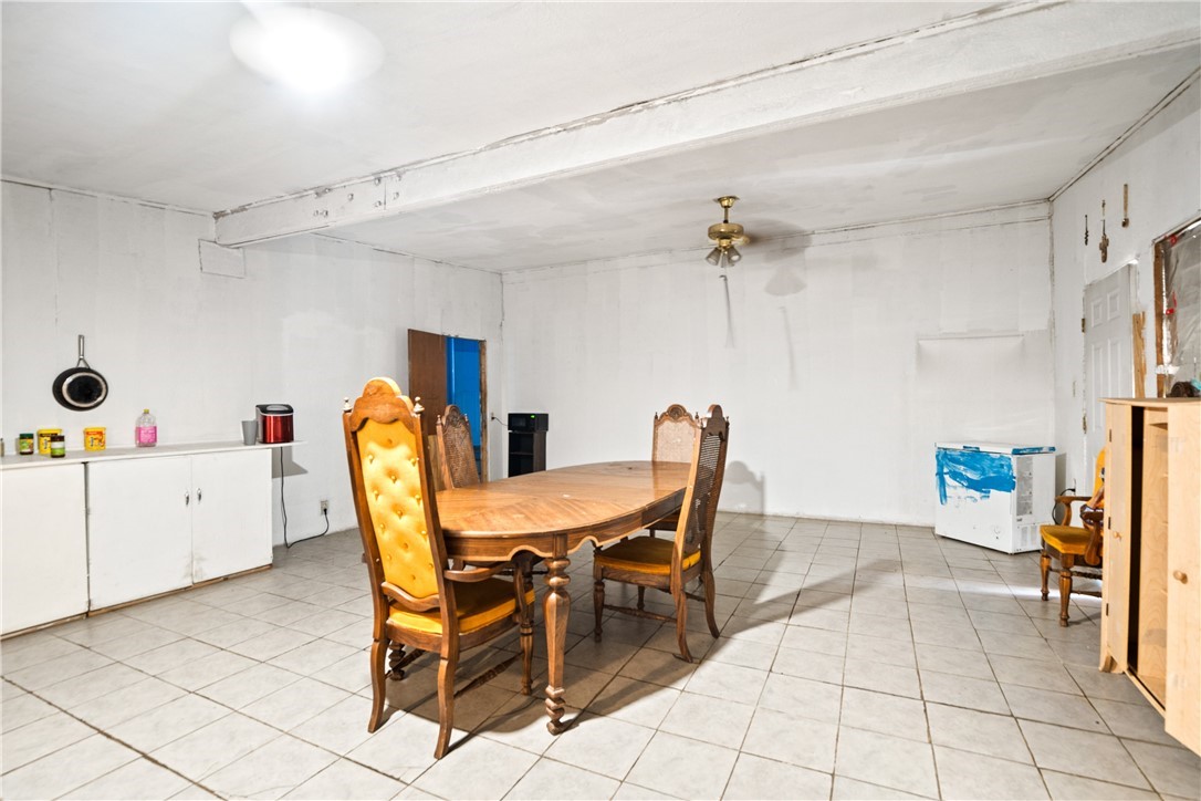 128 Northwest 6th Street Premont, TX 78375 - Photo 5 of 15 a dining room with furniture and a chandelier fan