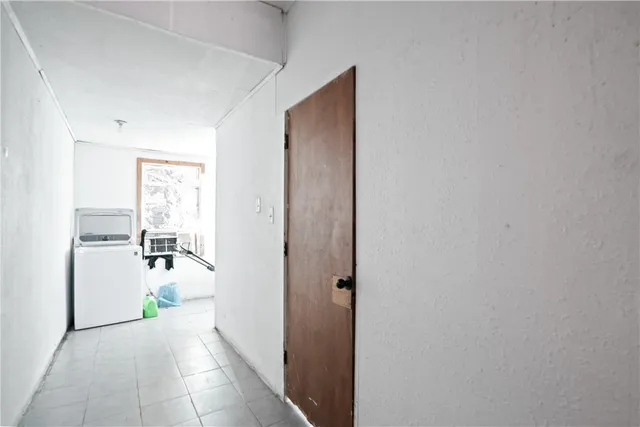 a view of a hallway with closet and livingroom