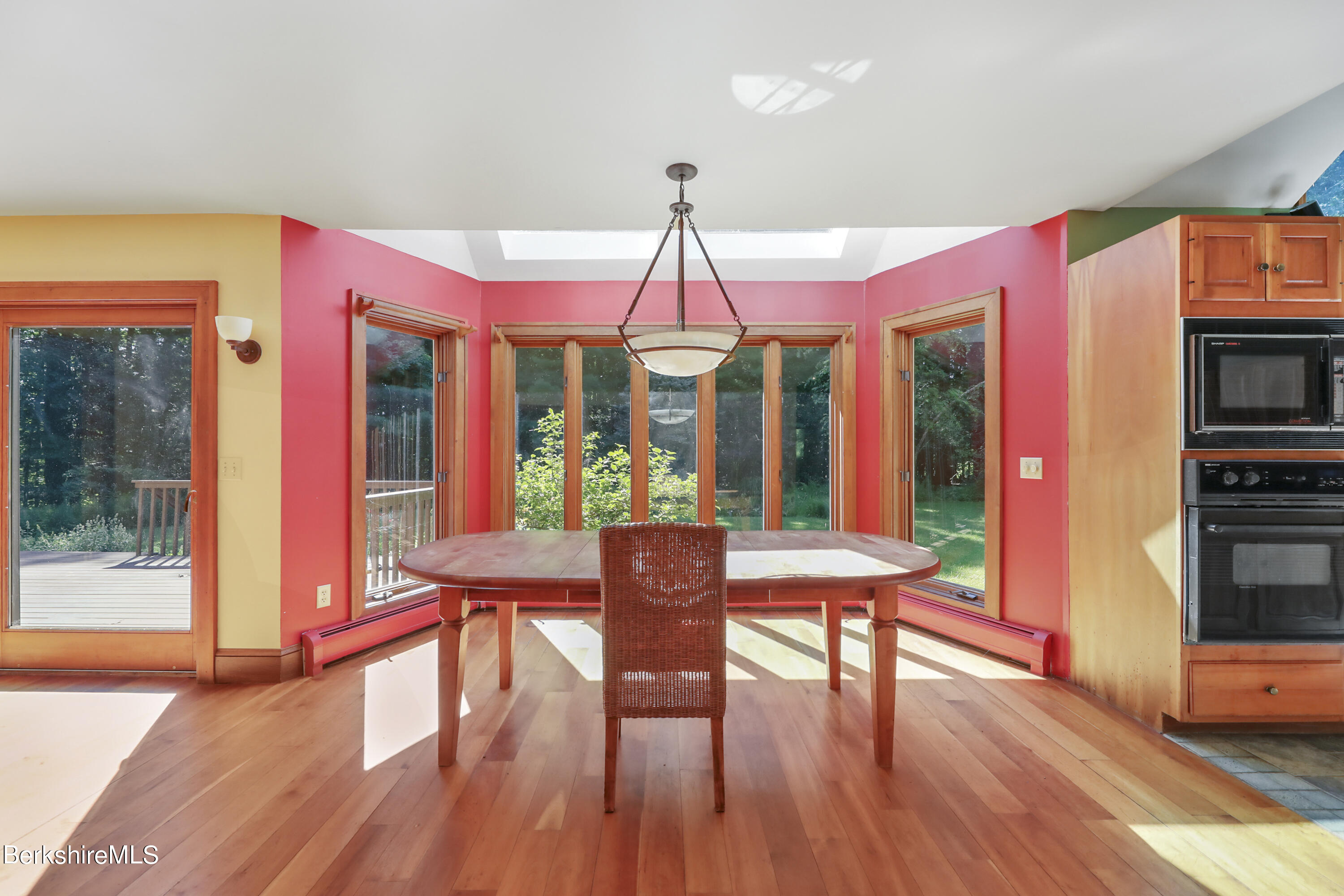 7 Fern Hill Road Great Barrington, MA 01230 - Photo 18 of 60 a dining room with furniture a chandelier and wooden floor