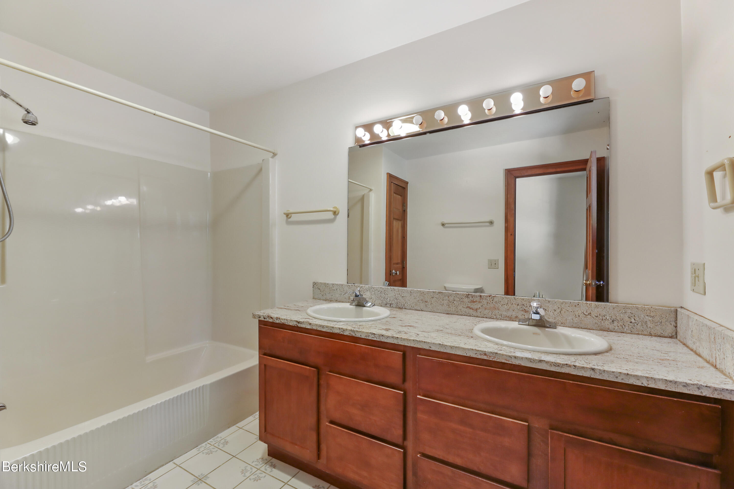 7 Fern Hill Road Great Barrington, MA 01230 - Photo 38 of 60 a bathroom with a granite countertop sink mirror and bathtub