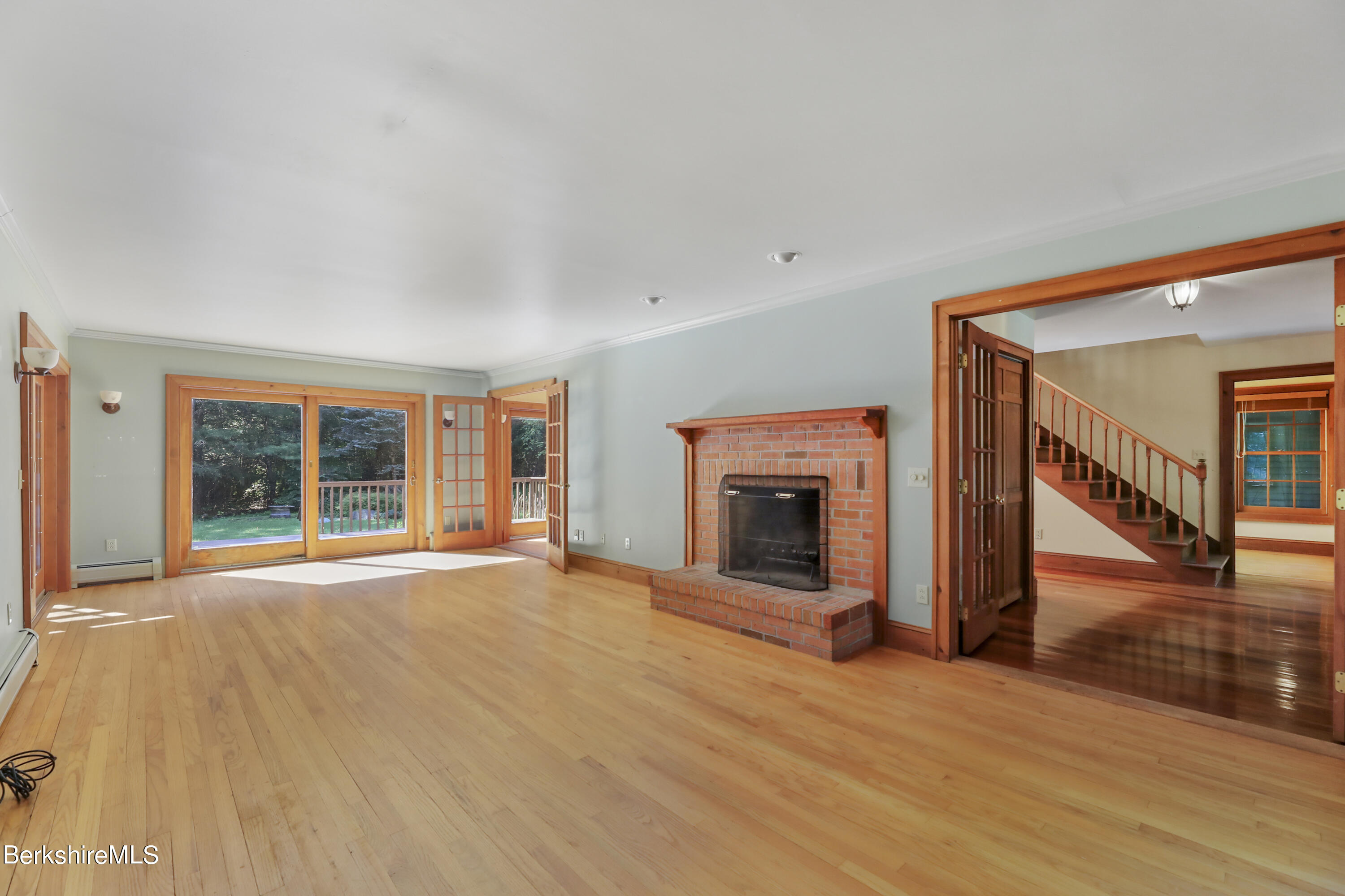 7 Fern Hill Road Great Barrington, MA 01230 - Photo 7 of 60 a view of empty room with wooden floor and fireplace