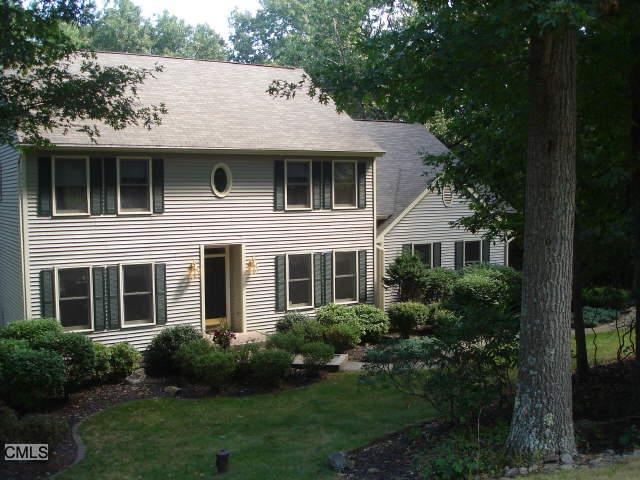 a aerial view of a house with a yard and potted plants