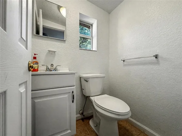 a bathroom with a toilet sink and vanity