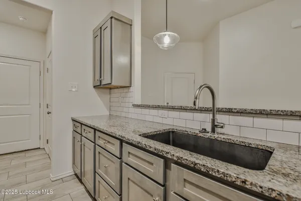 a kitchen with a sink and a mirror