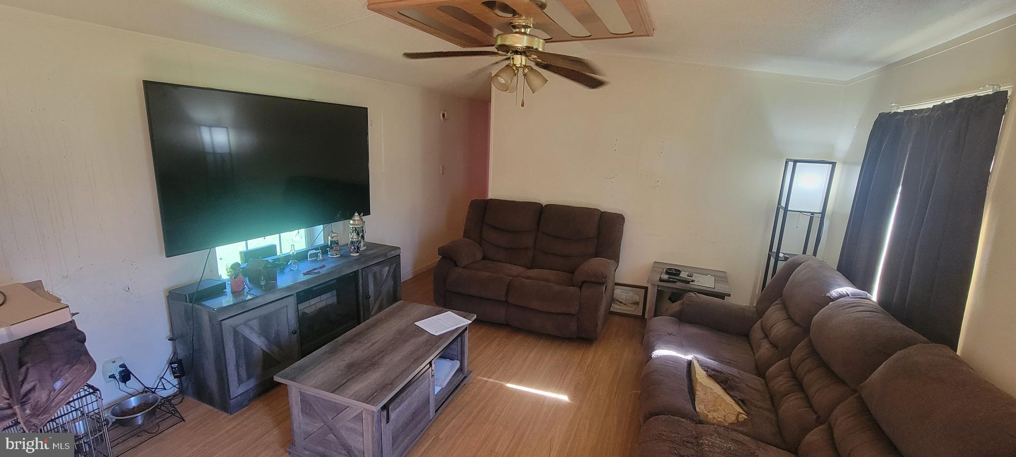 228 Gelden Road Felton, DE 19943 - Photo 3 of 10 a living room with furniture and a flat screen tv