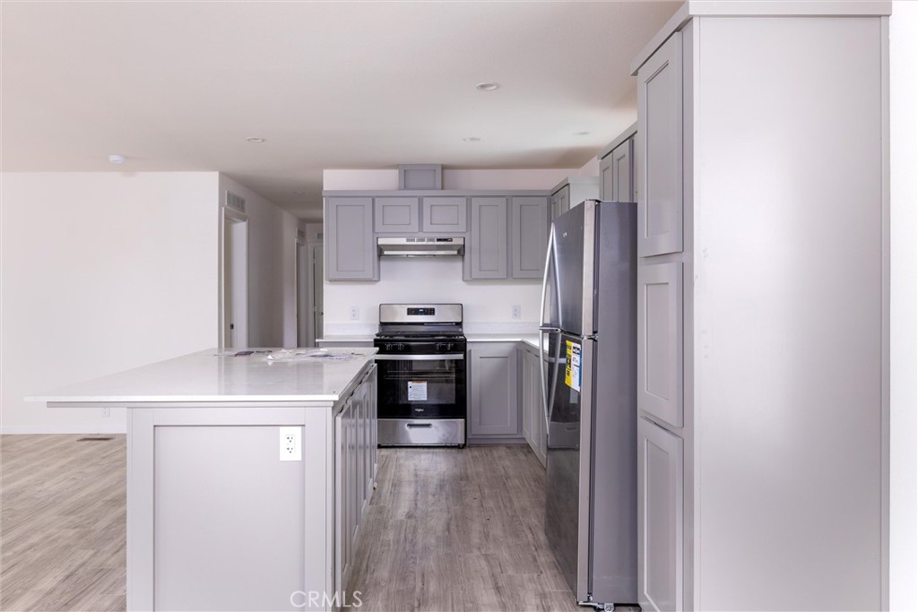 1255 Orcutt Road, Unit A11 San Luis Obispo, CA 93401 - Photo 11 of 22 a kitchen with a refrigerator and a stove top oven